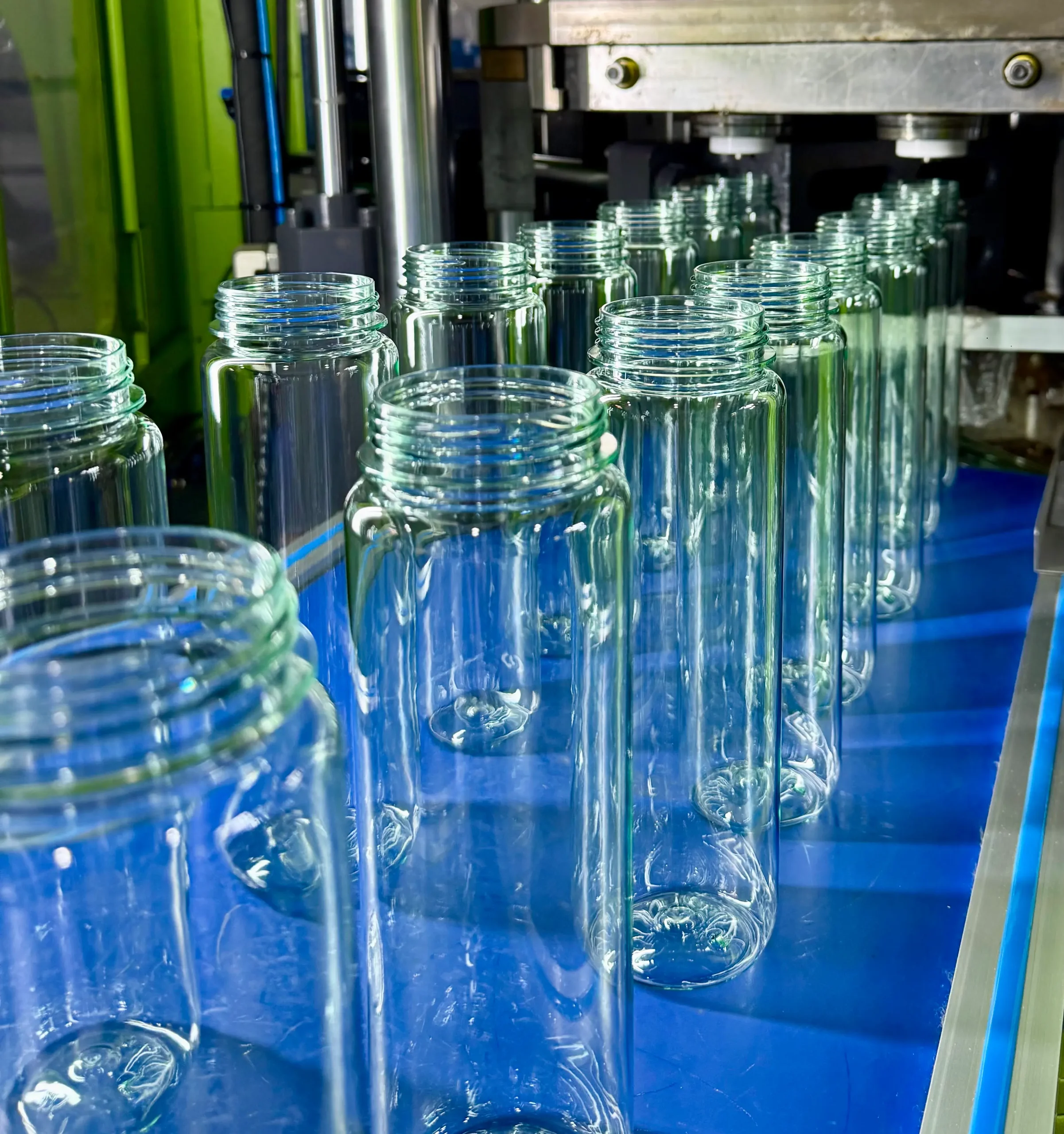 Clear plastic bottle preforms on the blow molding line at the Seliya factory