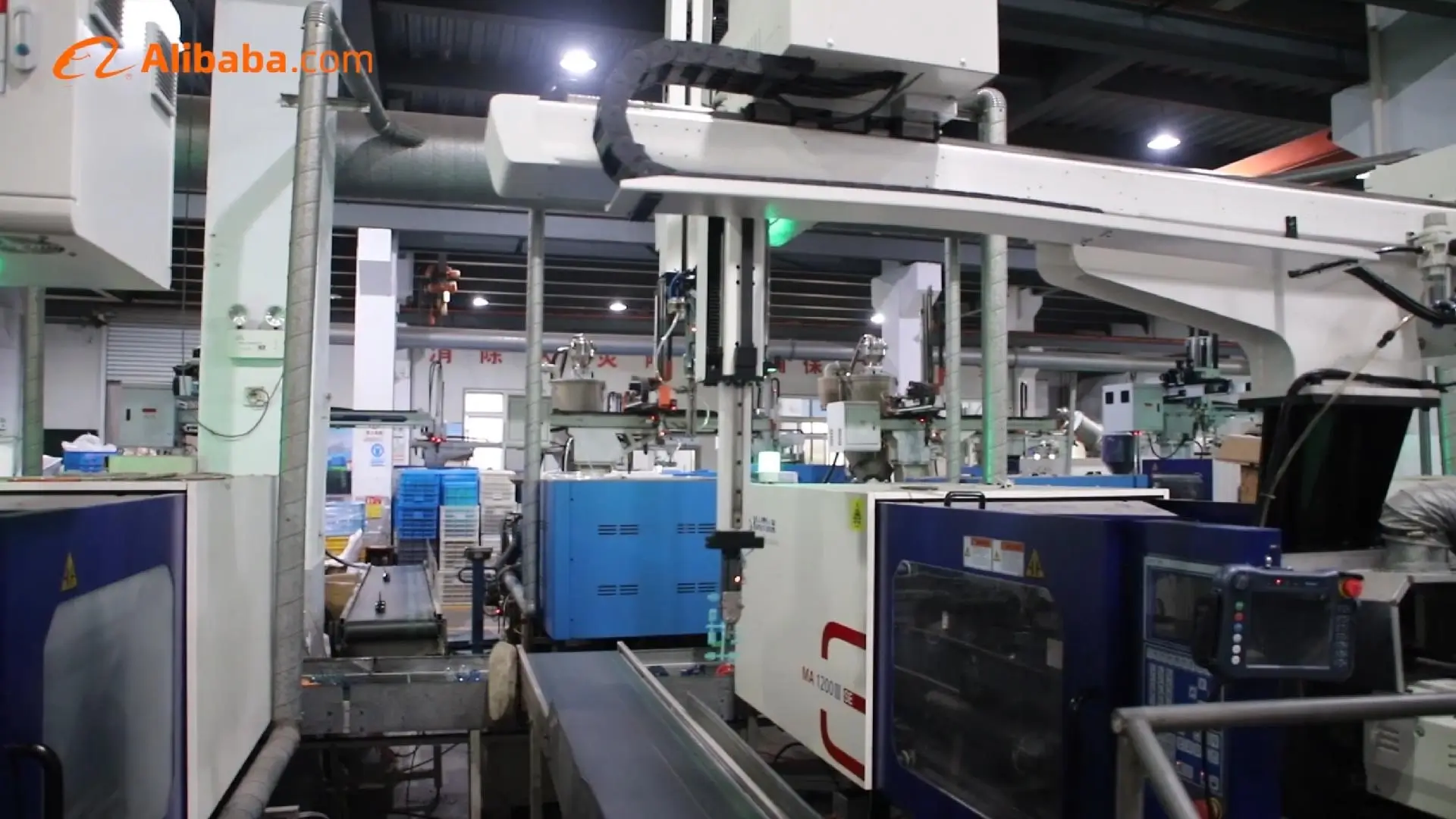 Injection molding machine with robotic arm in Seliya's workshop
